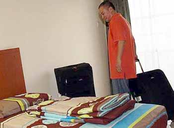 Room for improvement: Malaysia&rsquo;s new singles coach Hendrawan checking into his room at the hostel in Mount Kiara Monday.