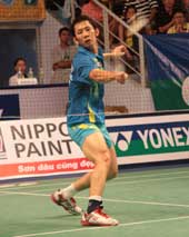 Bird man: Nguyen Tien Minh returns a drop shot from his Malaysian opponent Chong Wei Feng in the men's singles final yesterday. Minh won 21-7, 19-21, 21-14 to clinch the second title in succession.