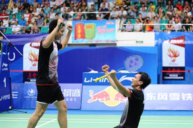 Mohd Ahsan and Hendra Setiawan (left) celebrate after winning the men's doubles final at World Badminton Championships in Guangzhou.