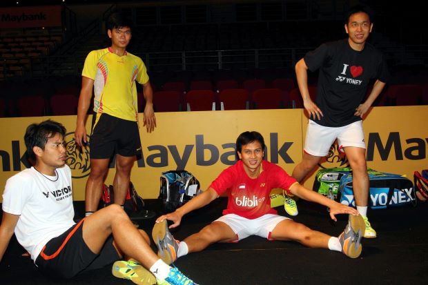 World champion men's doubles pair, Mohd Ahsan (2nd right) and Hendra Setiawan (right) warm down after a training session for the Malaysian Open badminton championship beginning on Wednesday at Bukit Jalil.