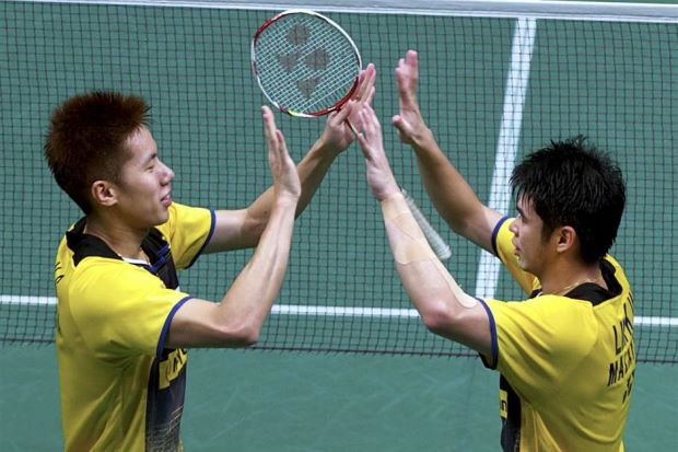 Lim Khim Wah (right) celebrates with Goh V Shem after beating Chinese pair Hong Wei-Chai Biao during the Malaysian Open last Sunday.