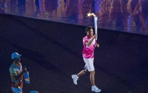 Lin Dan holding the torch and marches to the stadium at the Nanjing Youth Olympic Games Opening Ceremony