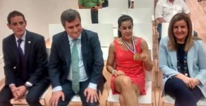 Carolina Marin sits with the government officials