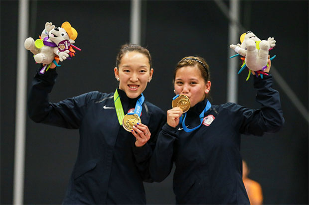 Eva Lee and Paula Lynn Obanana of USA pose for pictures after winning the 2015 Pan Am Games. (photo: GettyImages)