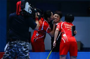 Chen Qingchen/Jia Yifan kiss their coach after winning the 2016 BWF World Superseries title. (photo: AFP)