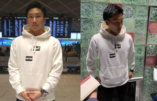 Kento Momota answers questions from reporters at Narita International Airport.