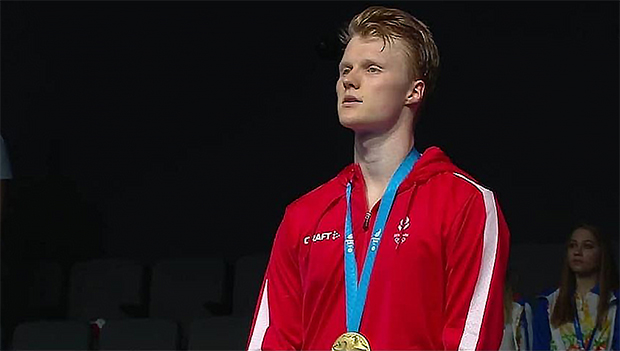 Anders Antonsen stands on the podium for the Denmark National Anthem following his victory in the men's singles final. (photo: European Games, Minsk)