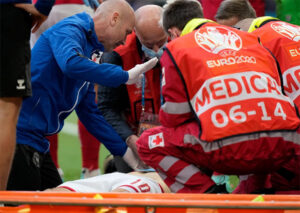 Both Morten Boesen and Anders Boesen perform cardiac resuscitation to restart Christian Eriksen's heart. (photo: AP)