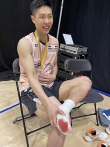 Chou Tien Chen sits with his gold medal after winning the 2025 Arctic Open, his sock stained with blood from a blistered foot. (Photo: Social Media)
