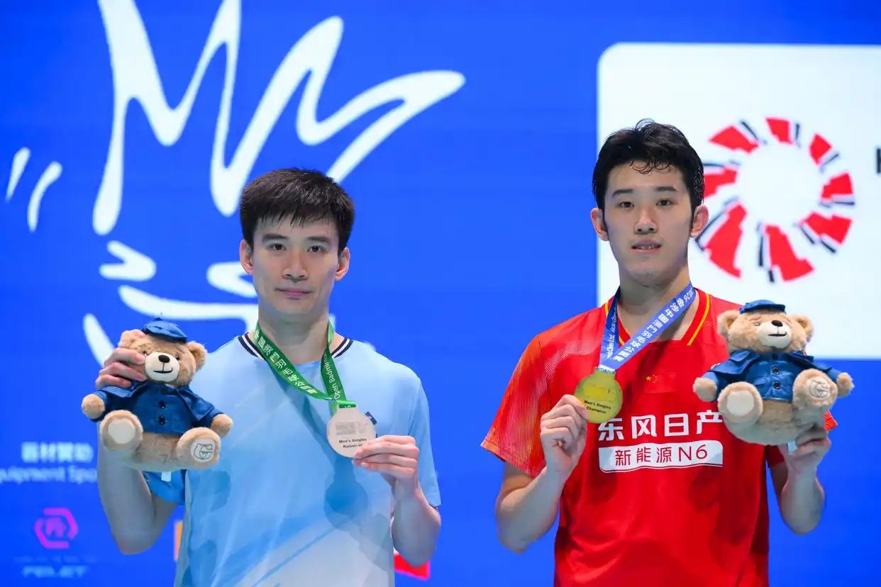 Hu Zhe An and Kantaphon Wangcharoen pose together during the awards ceremony at the 2026 Macau Open badminton tournament. (Photo: Xinhua)